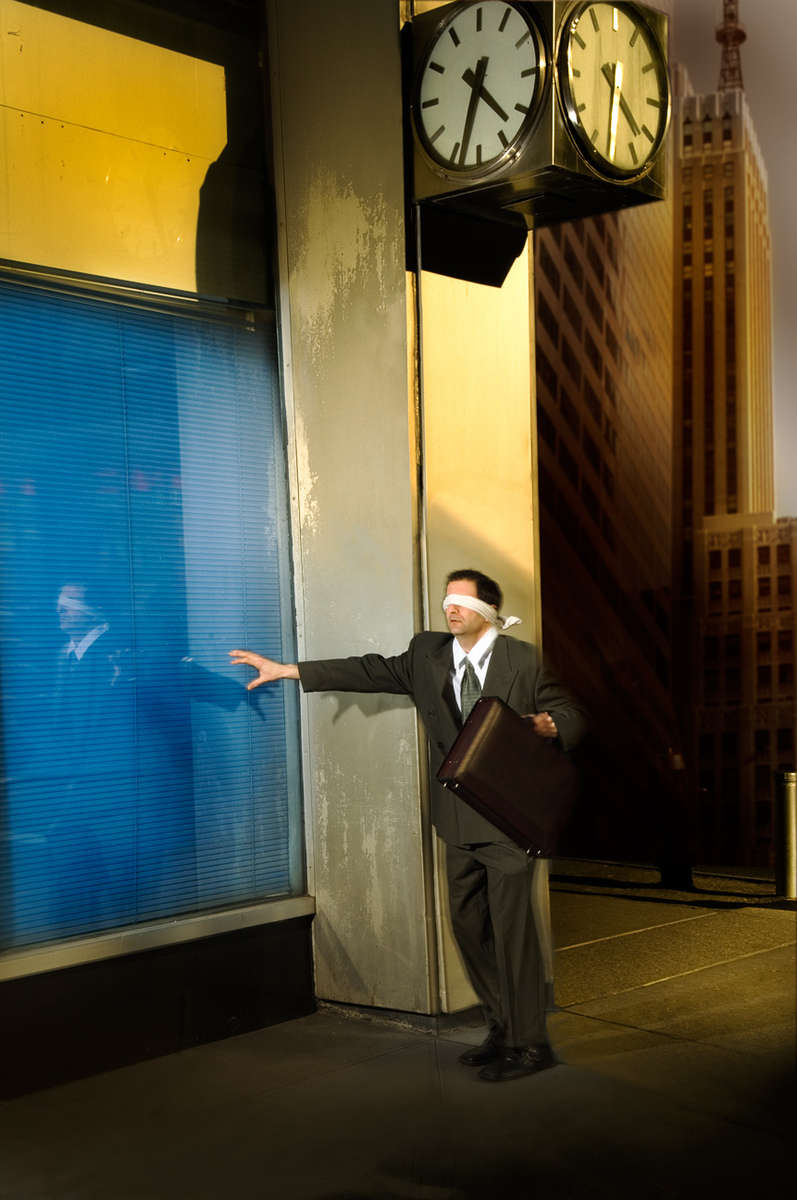 Actor Kostas Paragios in lower Manhattan in the Wall Str. area as blind businessman lost in the financial world of NYC.