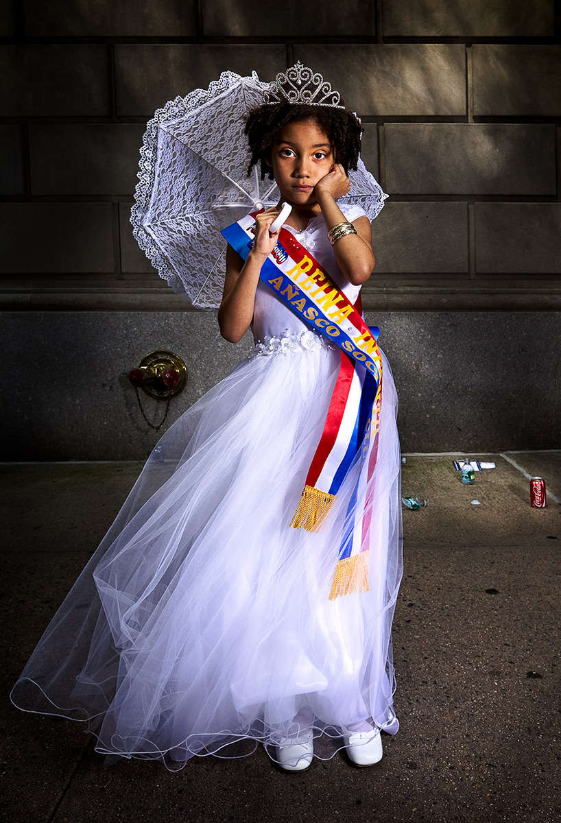 Young Latino girl at the NY National Puerto Rican Day Parade, photographed between Fifth Avenue and Madison Avenue on the Upper Eastside, NYC.
