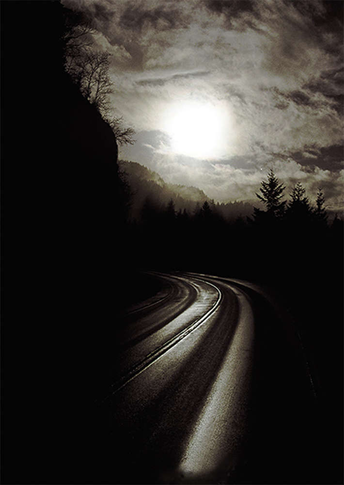 British Columbia road with sunset through mountain travel.