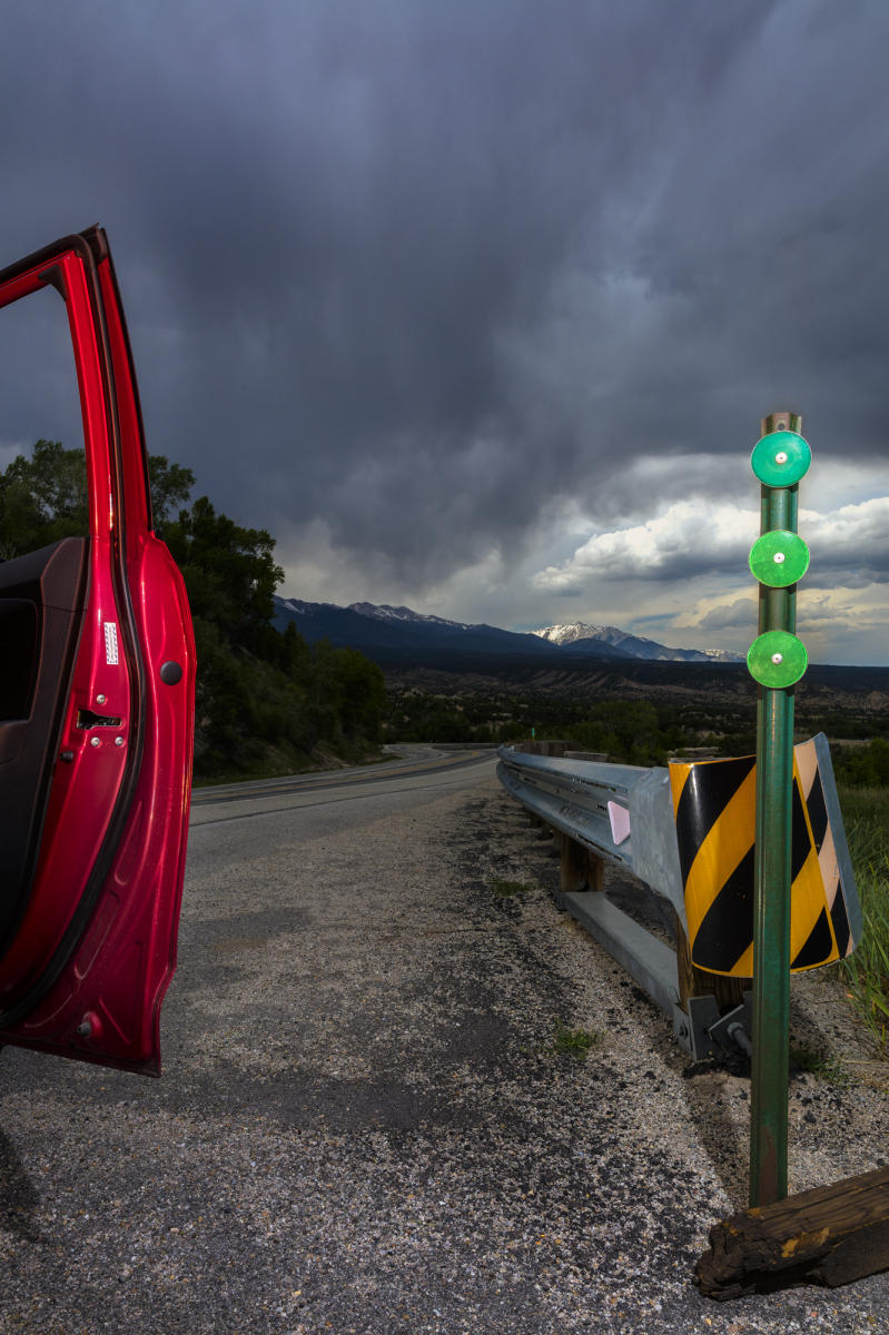 Primary colors of the road with a mountain view in the distance.