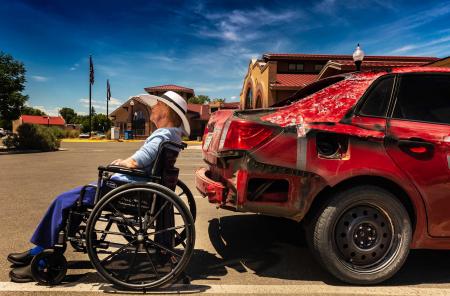Alamosa at the parking lot with mom.  Saw this car and loved the relation between the car tire and my mom's wheelchair.