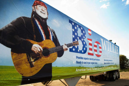 Truck with BioWillie promotional banner supporting truckers, farmers and helping the environment with the reduction of petroleum and utilizing biofuel from soy and corn products.