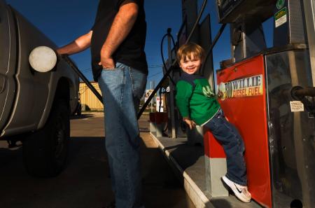 Dad and son filling up Chevy 2500 HD 4x4 with BioWillie biodiesel. 